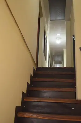a staircase in a building with wooden steps at #4 Private room close to Airport in Alajuela City