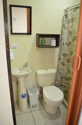 a bathroom with a toilet and a sink at #4 Private room close to Airport in Alajuela City