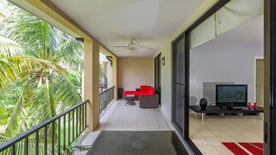 a balcony with a view of a living room at 3rd-floor space with modern décor recently renovated viewing over pool in Coco in Coco