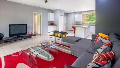 a living room with a couch and a tv at 3rd-floor space with modern décor recently renovated viewing over pool in Coco in Coco