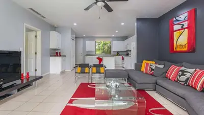 a living room with a couch and a glass table at 3rd-floor space with modern décor recently renovated viewing over pool in Coco in Coco