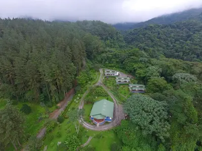 an aerial view of a house in the middle of a forest at Arenal Observatory Lodge & Trails in Fortuna