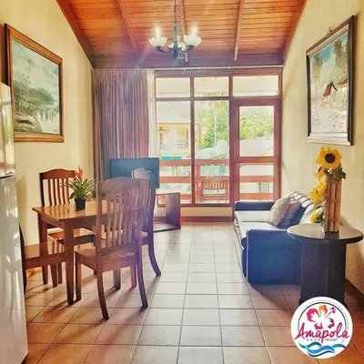 a living room with a couch and a table at Amapola Resort in Jacó