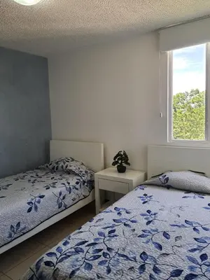 a bedroom with two beds and a window at 3Rooms Amaizing Beach Studio in Jacó