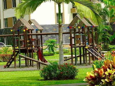 a playground in a park with a swing set at 3Rooms Amaizing Beach Studio in Jacó