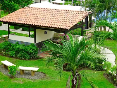 a small house with a bench in a garden at 3Rooms Amaizing Beach Studio in Jacó