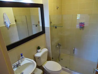 a bathroom with a shower and a toilet and a sink at 3Rooms Amaizing Beach Studio in Jacó