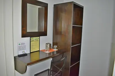 a bathroom with a wooden vanity with a mirror at Hotel Arenal Country Inn in Fortuna