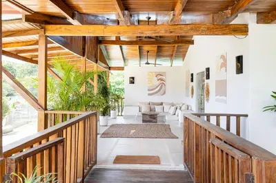 an open hallway with wooden ceilings and a wooden railing at Cafe Playa Negra Hotel in Playa Negra