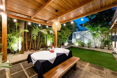 a patio with a table and a bench at Cafe Playa Negra Hotel in Playa Negra