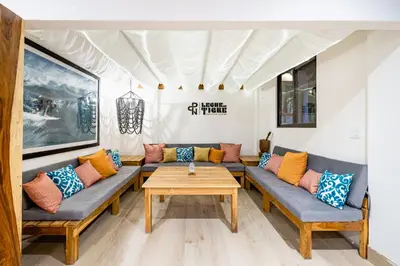 a living room with couches and a table at Cafe Playa Negra Hotel in Playa Negra