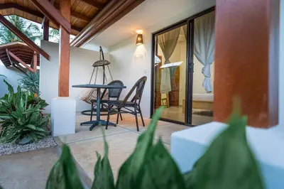 a room with a table and a chair on a porch at Cafe Playa Negra Hotel in Playa Negra