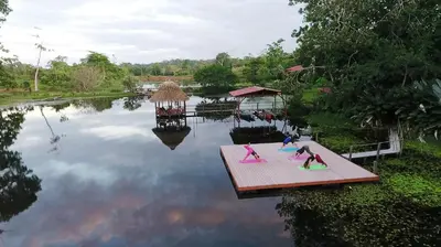 a group of children on a dock in a pond at Maquenque Lodge in Boca Tapada