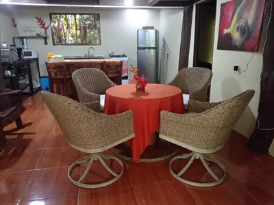 a table with chairs and a red table cloth at FINCA La PAZ - Sarapiqui in Puerto Viejo
