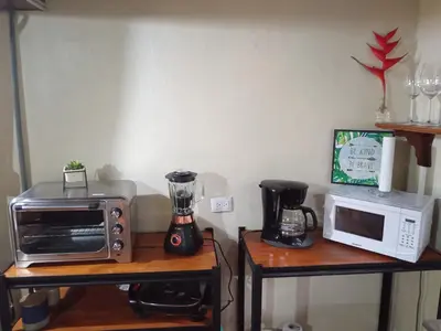 a kitchen with a toaster oven and a microwave at FINCA La PAZ - Sarapiqui in Puerto Viejo