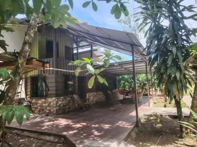 an outside view of a house with trees at FINCA La PAZ - Sarapiqui in Puerto Viejo