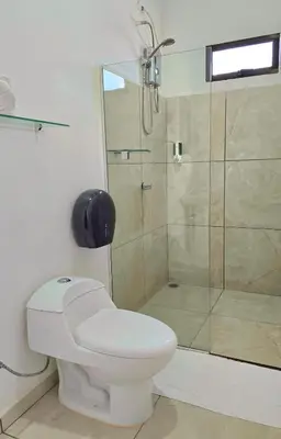 a bathroom with a toilet and a shower at Cattleya Family in Monteverde Costa Rica
