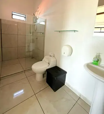 a bathroom with a toilet and a shower and a sink at Cattleya Family in Monteverde Costa Rica