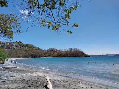 a view of a beach with people in the water at Alouatta Guesthouse en Las Catalinas - Beachfront GUESTHOUSE for 6 people in Playa Danta