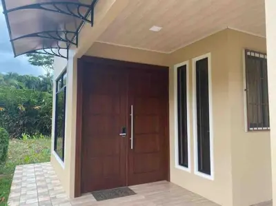 a wooden door of a house with a porch at Lisa Loft Boutique Apartment in Fortuna