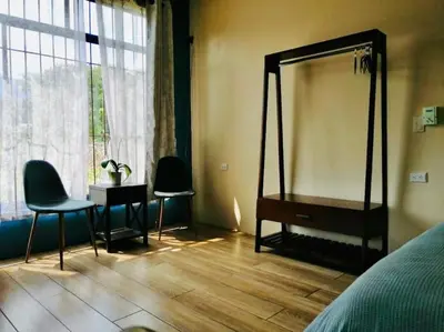 a bedroom with a mirror and two chairs and a table at Lisa Loft Boutique Apartment in Fortuna