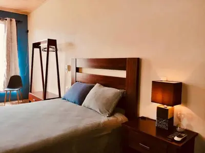 a bedroom with a bed and a table with a lamp at Lisa Loft Boutique Apartment in Fortuna