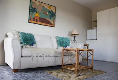 a living room with a white couch and a table at Vista Canyon Inn in Santa Ana