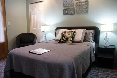 a bedroom with a bed with a teddy bear on it at Vista Canyon Inn in Santa Ana