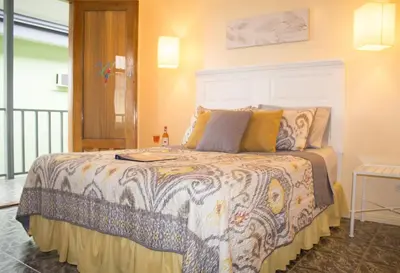 a bedroom with a bed with a colorful bedspread at Vista Canyon Inn in Santa Ana