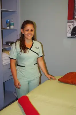 a woman is standing next to a bed at Vista Canyon Inn in Santa Ana