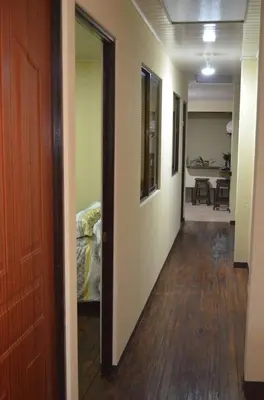a hallway leading to a room with a table and chairs at #5 Private room close to Airport in Alajuela City