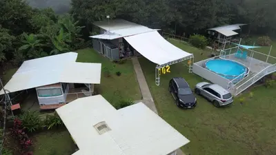 an aerial view of a house with a car parked next to a pool at Casa Mandala by Dreamcatcher in Sarchí