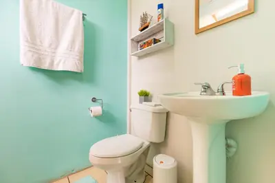 a bathroom with a white toilet and a sink at Casa Mandala by Dreamcatcher in Sarchí