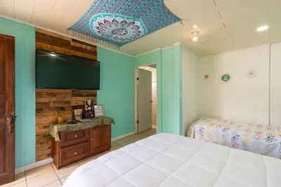 a bedroom with a large bed and a blue ceiling at Casa Mandala by Dreamcatcher in Sarchí