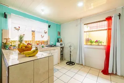 a kitchen with a bowl of fruit on a counter at Casa Mandala by Dreamcatcher in Sarchí