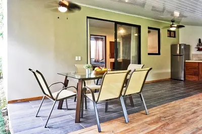 a dining room with a table and chairs at Villa Flamingo in Santa Teresa Beach