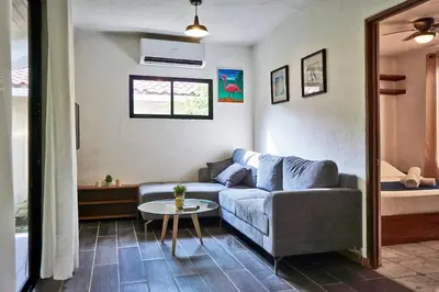 a living room with a couch and a table at Villa Flamingo in Santa Teresa Beach