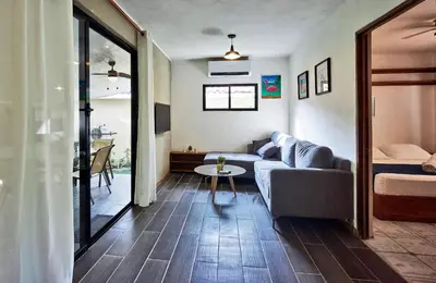 a living room with a couch and a table at Villa Flamingo in Santa Teresa Beach