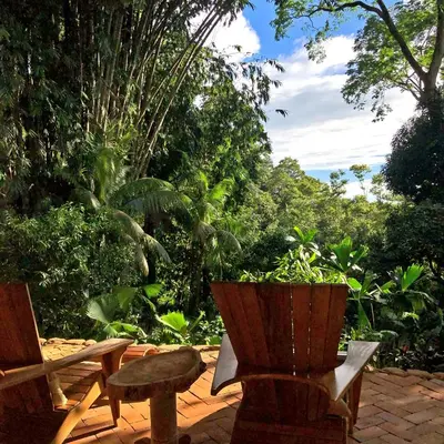 a patio with a bench and a potted plant at Cascada Verde Eco Lodge & Hostel in Uvita