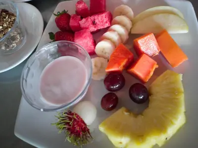 a plate of food with fruit and other foods at Puntarenas Bed & Coffee by Aldea in Puntarenas