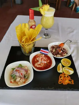 a tray with plates of food and chips and a drink at Puntarenas Bed & Coffee by Aldea in Puntarenas