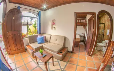a living room with a couch and a table at Sol y Luna Apartments in Fortuna