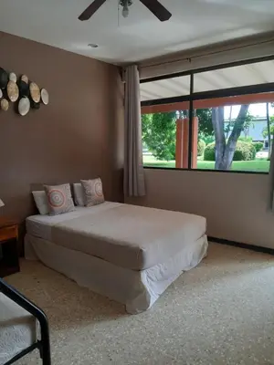 a bedroom with a bed and a large window at Hotel Diriá Santa Cruz in Santa Cruz