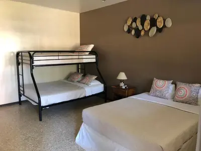 a bedroom with two bunk beds and a lamp at Hotel Diriá Santa Cruz in Santa Cruz