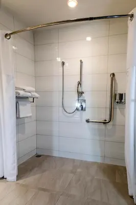 a bathroom with a shower with a glass door at D Sabana Hotel San José in San José