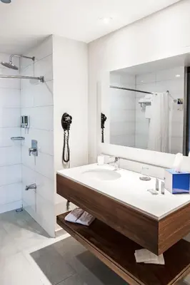 a bathroom with a sink and a mirror at D Sabana Hotel San José in San José