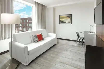 a living room with a white couch and a table at D Sabana Hotel San José in San José
