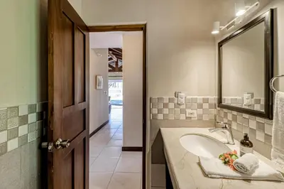 a bathroom with a sink and a mirror at Villa Sol 35 in Playa Hermosa