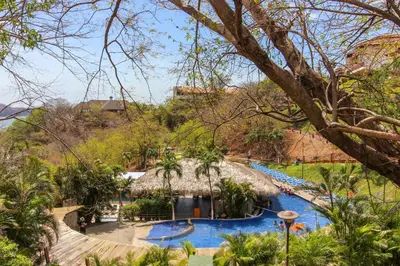 a resort with a swimming pool and a lazy river at Villa Sol 35 in Playa Hermosa
