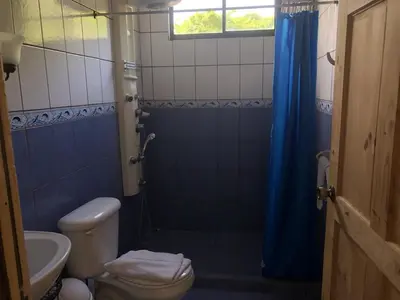 a bathroom with a shower with a toilet and a sink at Villas Luna de Miel in Carmen